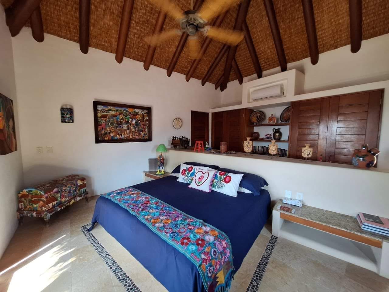 Primary bedroom with palapa roof