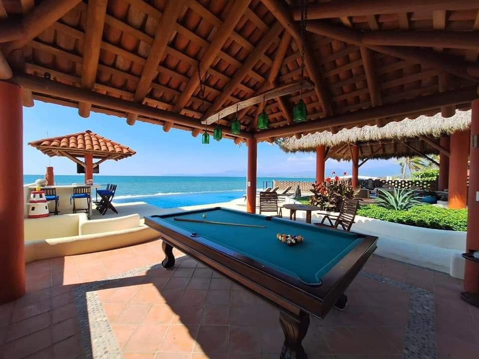 Covered game area with pool table and ocean view