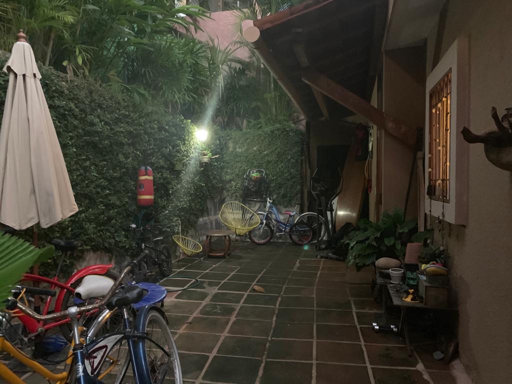 Covered service patio beside the house