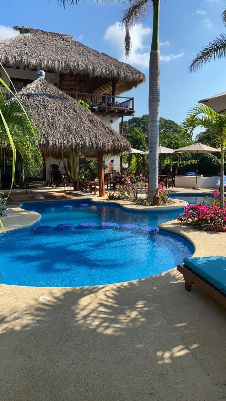 Daytime pool and hotel tower