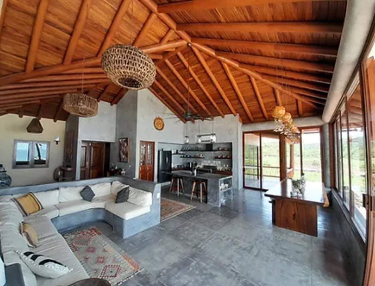 Open-concept living room with vaulted Parota ceiling